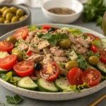 A bowl of fresh Italian Tuna Salad with tuna, tomatoes, cucumbers, and parsley.